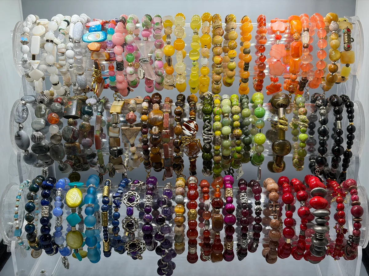 Full display of Patty's handcrafted stretch bracelets in a wide range of colors and stones