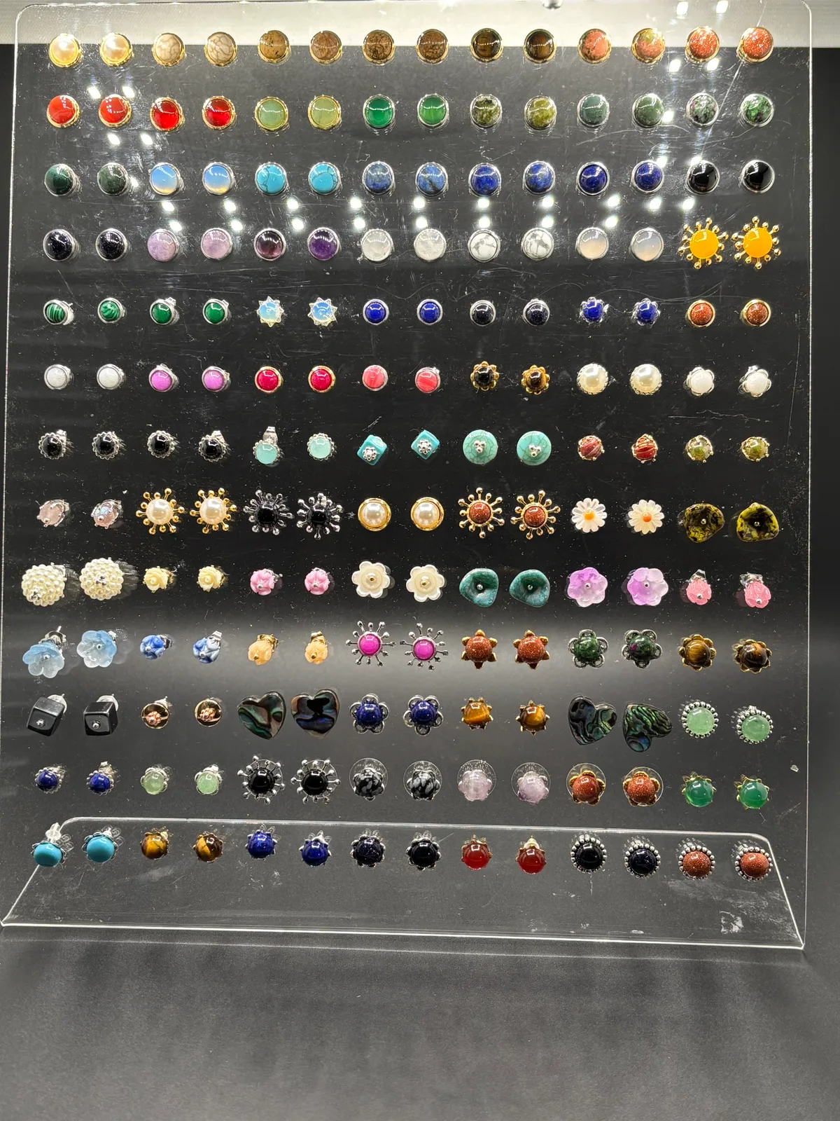 Full display of Patty's handcrafted stud earrings in a wide variety of stones and colors