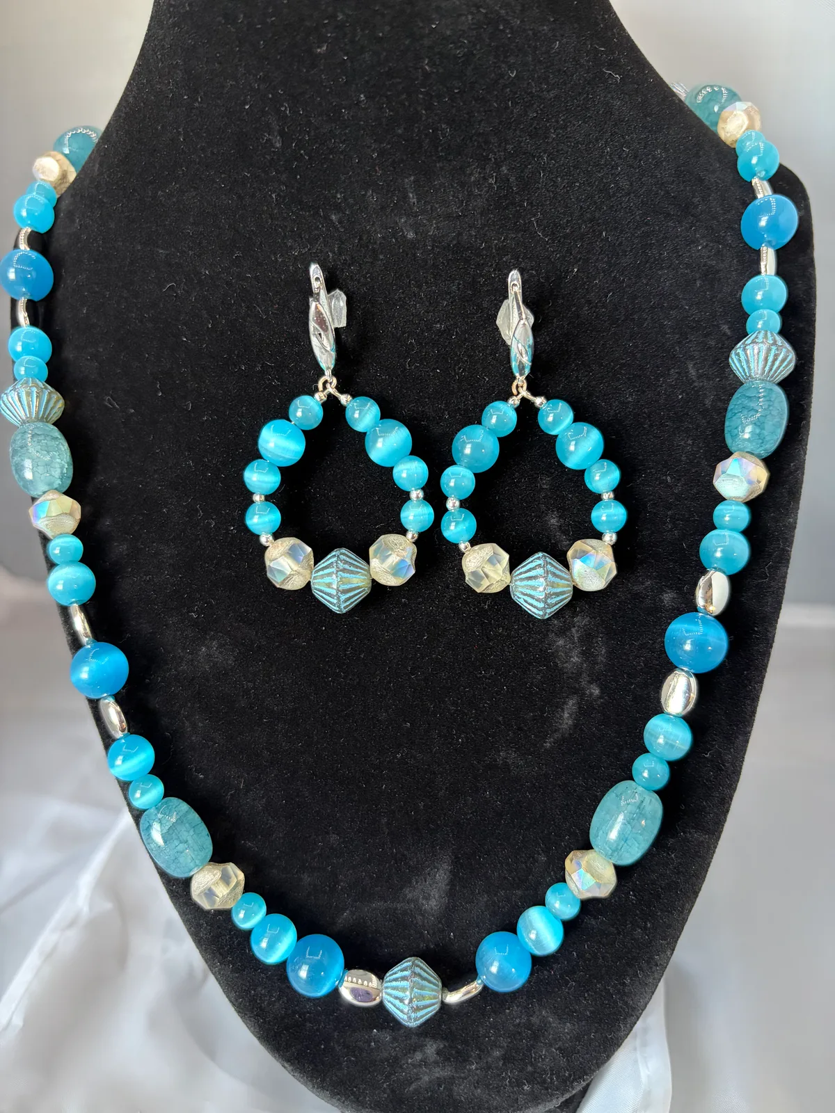 Aqua blue beaded necklace with matching hoop earrings handcrafted by Patty