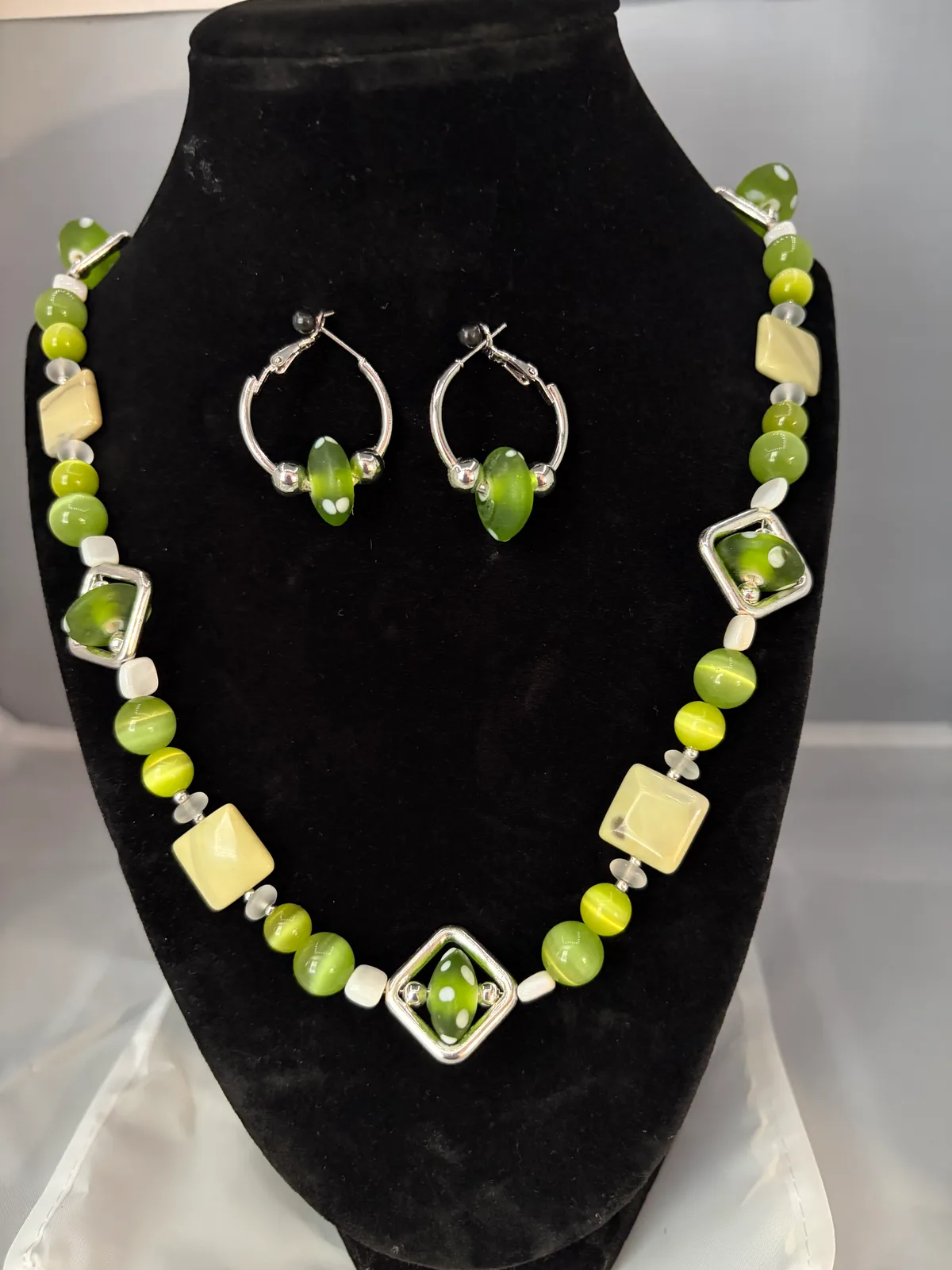 Green and white geometric necklace with hoop earrings handcrafted by Patty
