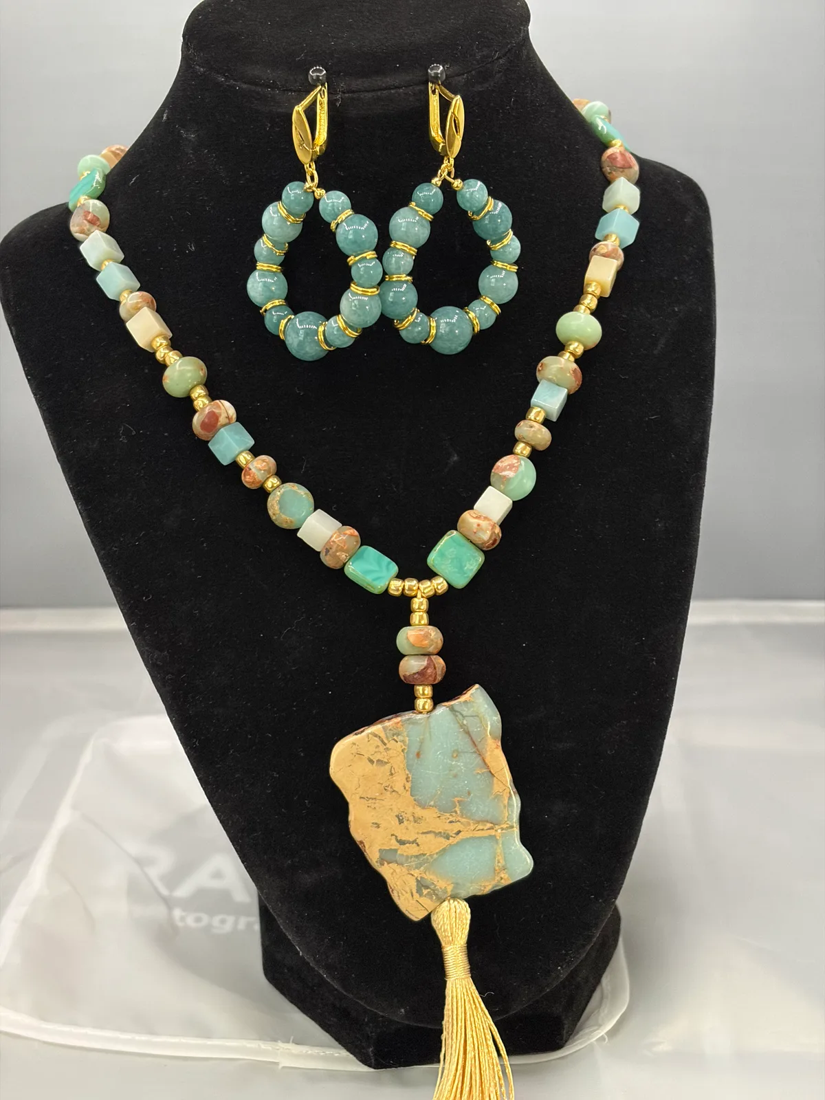 Pale blue stone pendant necklace and earring set handcrafted by Patty