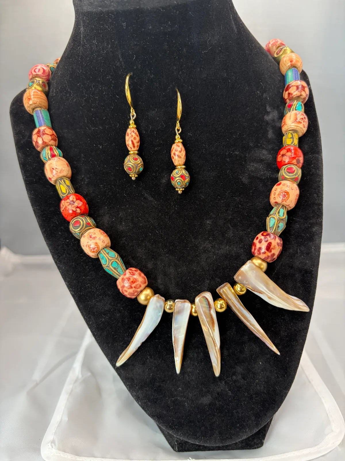 Pastel shell and spike necklace and earring set handcrafted by Patty